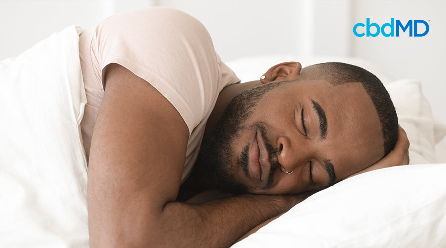 man enjoying a good sleep in white comforter