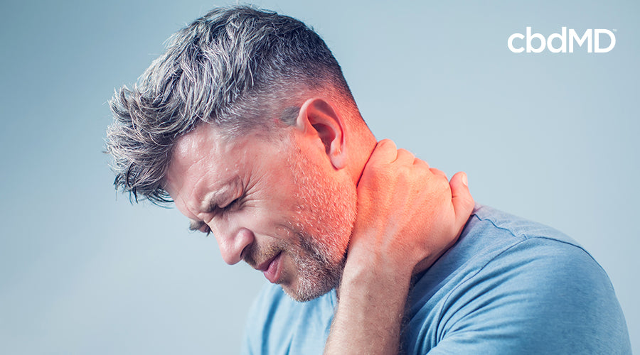 A man holding his neck with neck pain