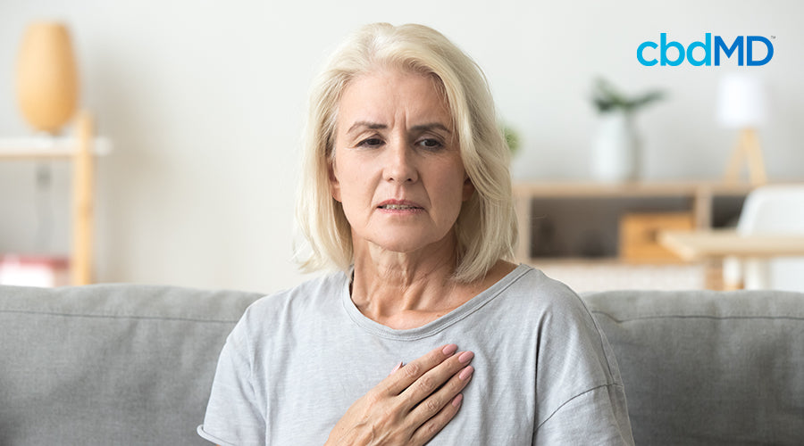 A woman that is stressed putting her hand on her chest