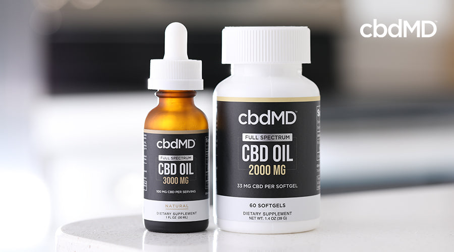 cbdMD full spectrum cbd oil 3000mg natural tincture bottle next to a bottle of cbdMD full spectrum cbd oil 2000mg softgels container