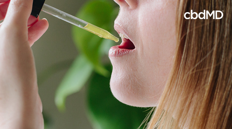 woman taking cbd oil