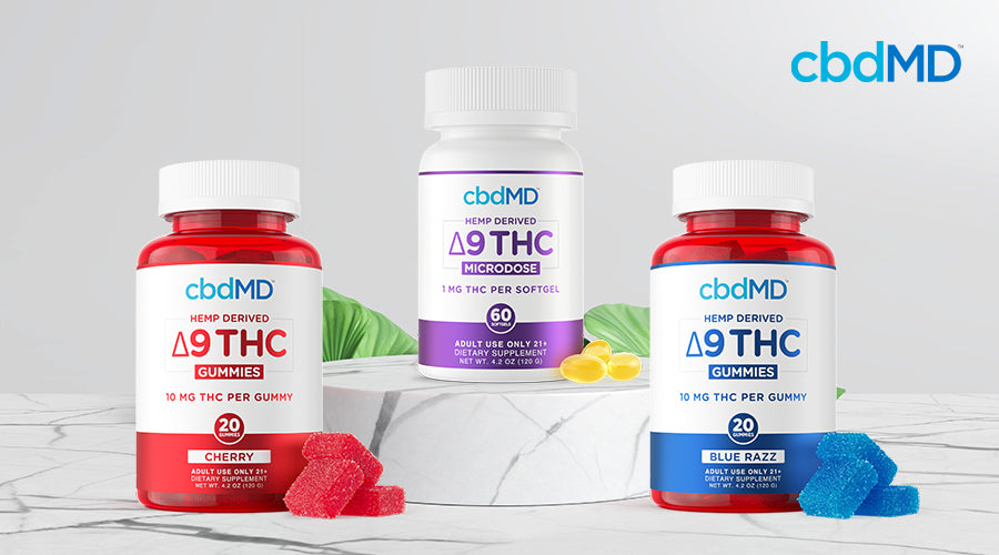 cbdMD hemp derived delta 9 thc gummies 10 mg cherry and blue razz containers with a bottle of cbdMD hemp derived delta 9 thc microdose softgels 1 mg in the middle