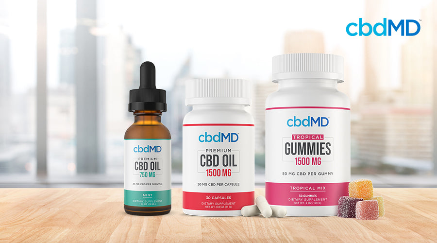 cbdMD cbd oil 750 mg mint tincture cbd oil 1500 mg capsules and tropical gummies 1500 mg containers sitting on a table next to each other