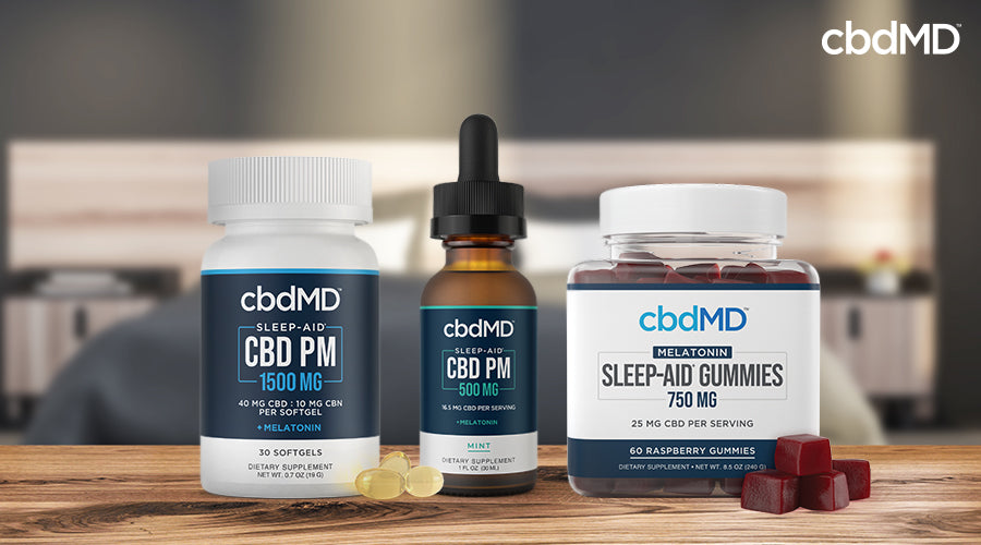 cbdMD sleep aid cbd pm 1500 mg melatonin softgels sleep aid 500 mg melatonin mint tincture and melatonin sleep aid gummies 750 mg raspberry containers next to each other on a wooden table 