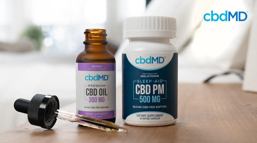 Several cbd products from cbdmd sit in a line on a counter