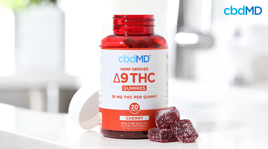 Delta 9 thc gummies 10 mg cherry with the cap off next to delta 9 gummies - cbdMD