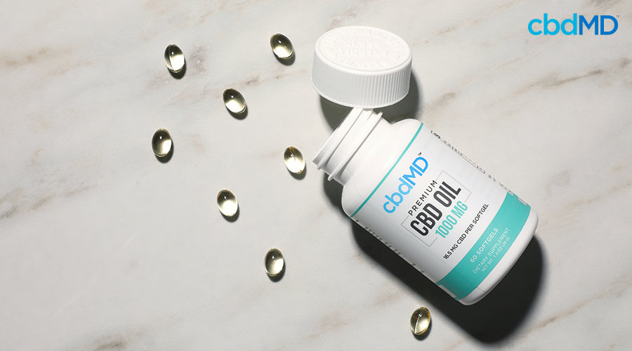 Premium cbd oil 1000 mg softgels with the lid taken off next to individual cbd softgels - cbdMD
