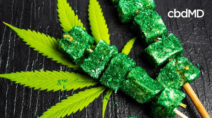Shredded hemp covers skewered soy squares on top of a cannabis leaf