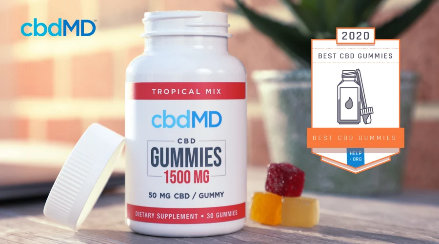 A bottle of Help.org Best CBD Gummies Winner 1500 mg CBD Gummies from cbdMD outdoors on a wooden table