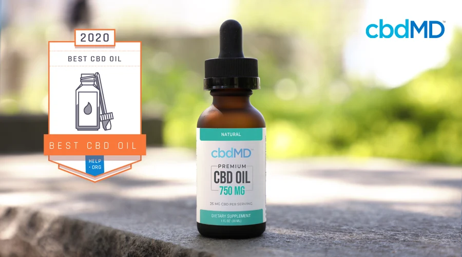 A bottle of Help.org Best CBD Oil Winner 750 mg CBD Oil from cbdMD on a granite table