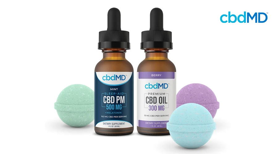 Restore CBD bath bomb sits behind bottle of mint flavored CBD PM 500 mg sleep aid next to berry flavored bottle of 300 mg CBD oil tincture by cbdMD with Rejuvenate and Relax CBD Bath bombs sitting next to bottle