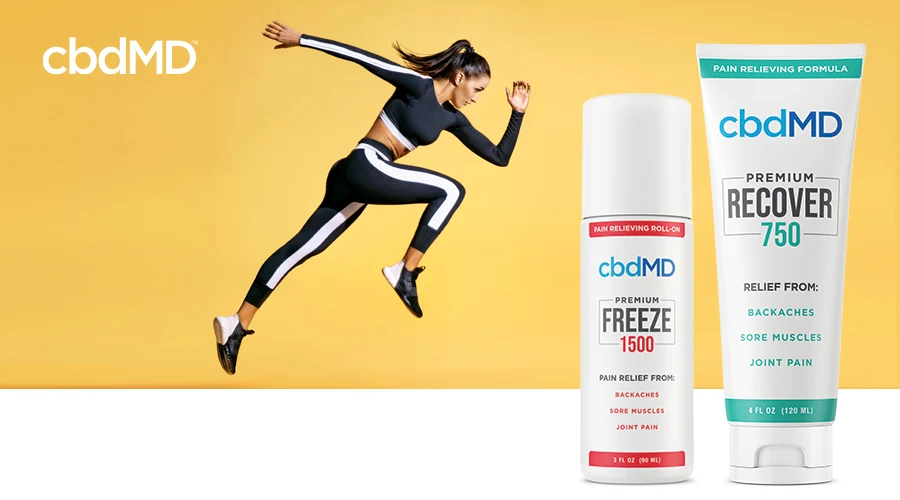 An athletic woman poses in a sprint against a yellow background next to cbdMD topicals 1500 mg Freeze and 750 mg Recover