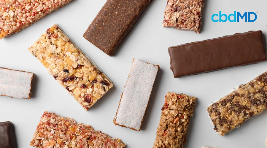 Variety of protein bars with assortment of nuts, berries, fruits, oats, and chocolate