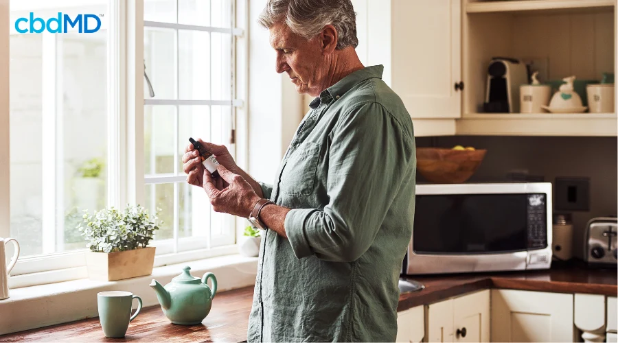 Father Using CBD in Morning Tea for Wellness Routine