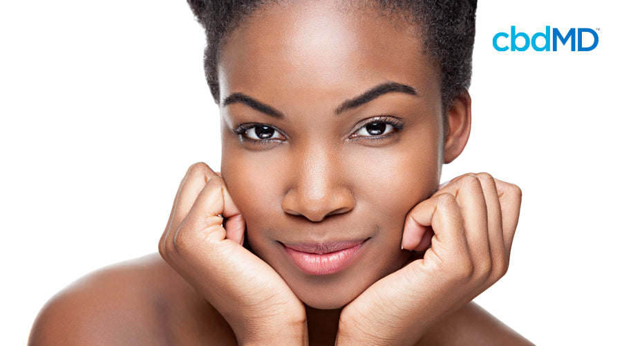 An attractive dark skinned woman shows off her impeccably clear skin