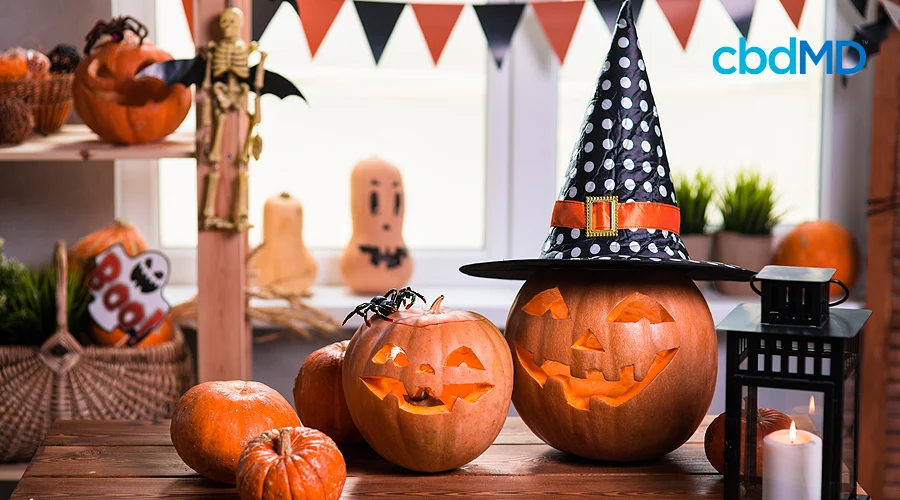 An arrangement of jack o lanterns sits on a table surrounded by additional halloween decorations