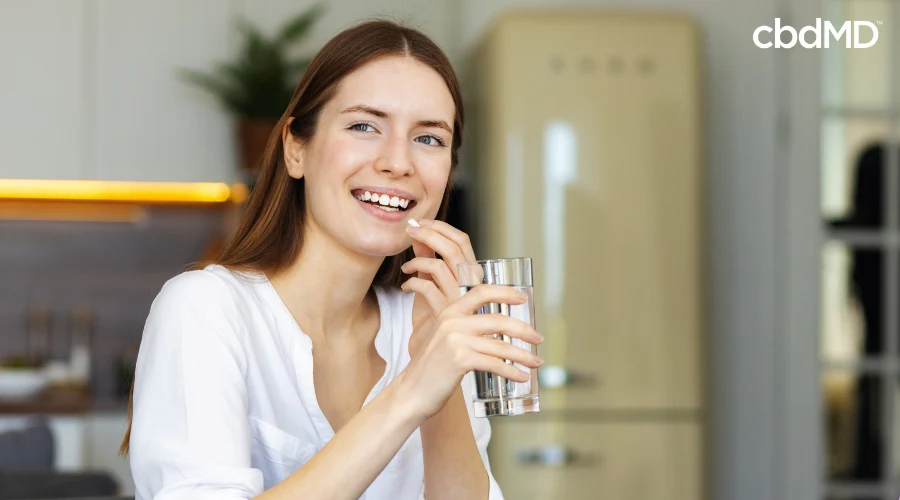 Happy Woman Taking CBD Capsule as Part of a Self Care Plan