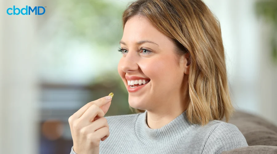 Happy Woman Taking Daily CBD Capsule