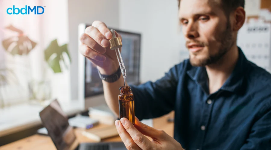 Man Taking CBD Tincture for Better Mental Health