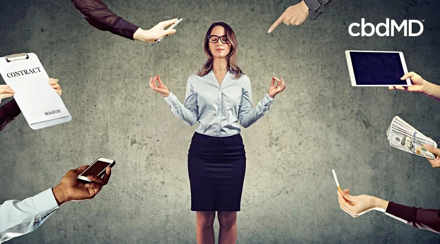 Business woman stand in center with hands reach towards her holding variety of work supplies