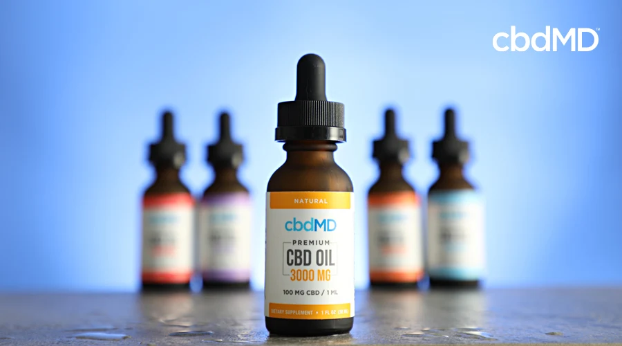 A bottle of 3000 mg cbd oil sits in the foreground with other bottles of cbd tincture in the background