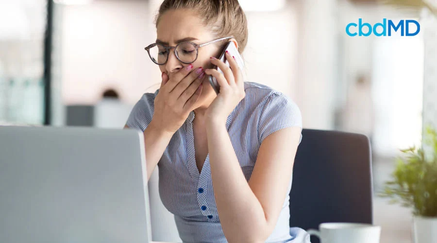 Woman Sleepy at Desk on Mobile Phone
