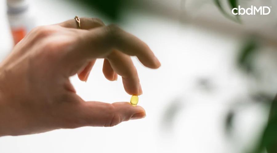 Person Taking Delta 9 THC Capsule from cbdMD