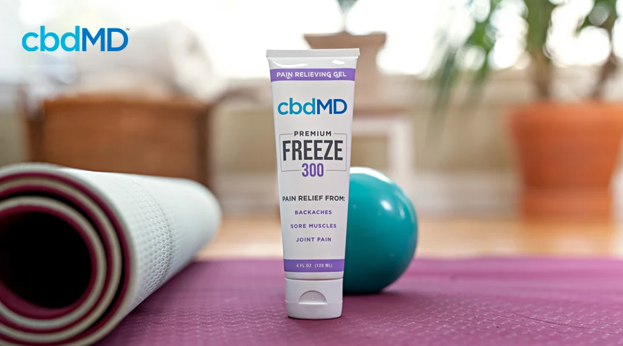 A bottle of 300 mg CBD freeze from cbdmd sits next to some exercise equipment