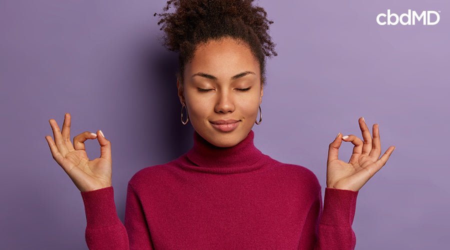 A woman meditating with her hands up in the air