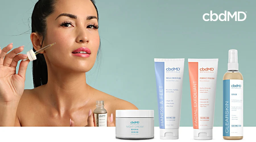 An attractive asian woman puts cbd skin serum on her face with cbdmd botanicals products in the foreground