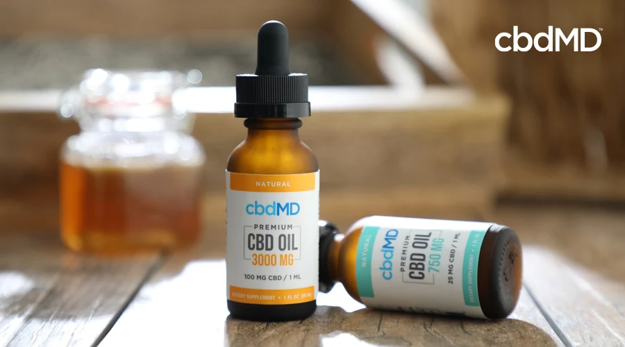Two bottles of cbd oil from cbdmd in 3000 mg and 750 mg strength sit side by side