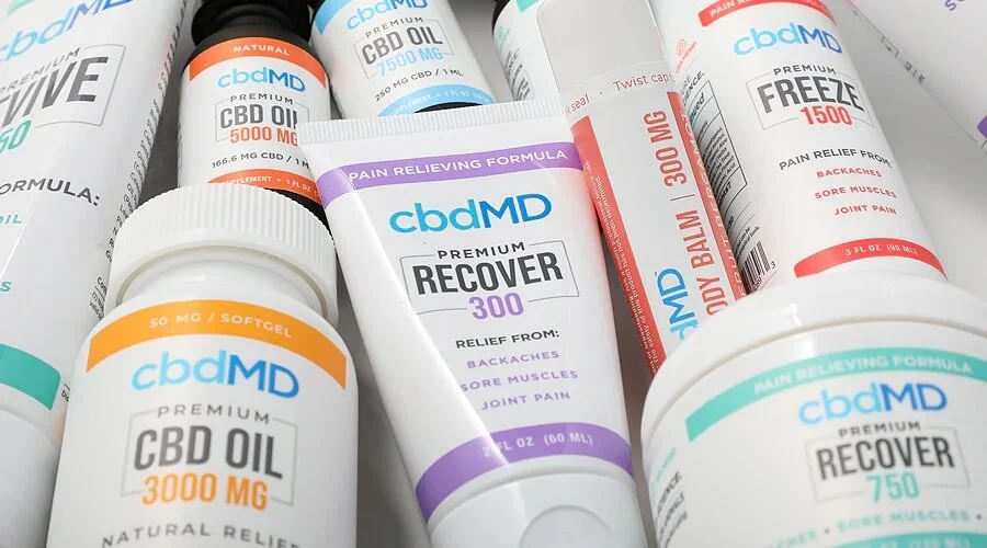 A group of topical and oral products from cbdmd sit together on a table