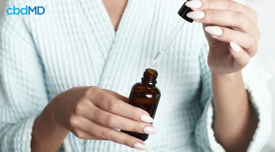 Woman in Pajamas Using CBD for Sleep