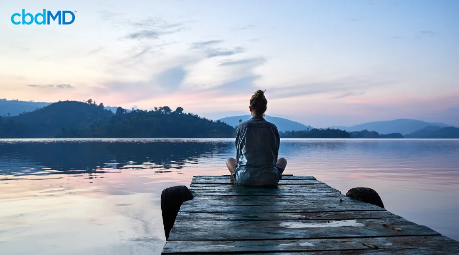 Woman Sitting on Dock to Relax for Mental Health