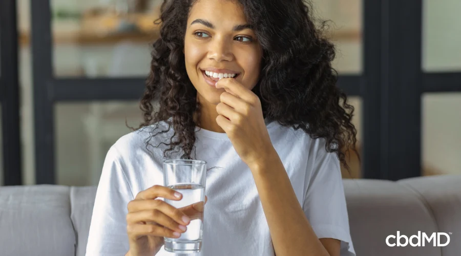 Woman Taking Calming CBD Capsule to Relax