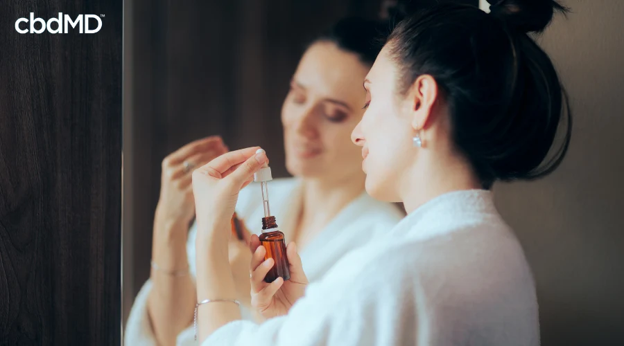 Woman Taking CBD Tincture from cbdMD