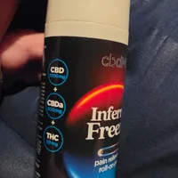 Customer-uploaded image. Click to see more details. The image represents: A roll-on pain relief product bottle containing CBD, CBDa, and THC, with a cream-colored cap and black label featuring red and blue gradient design elements.