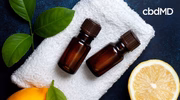 Essential oil bottles on a towel with lemon slices and green leaves for stress relief