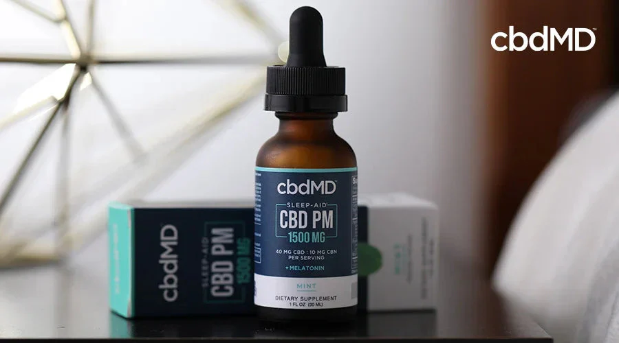 CBD oil sleep aid bottle with dropper on nightstand, mint flavor, boxed packaging in background