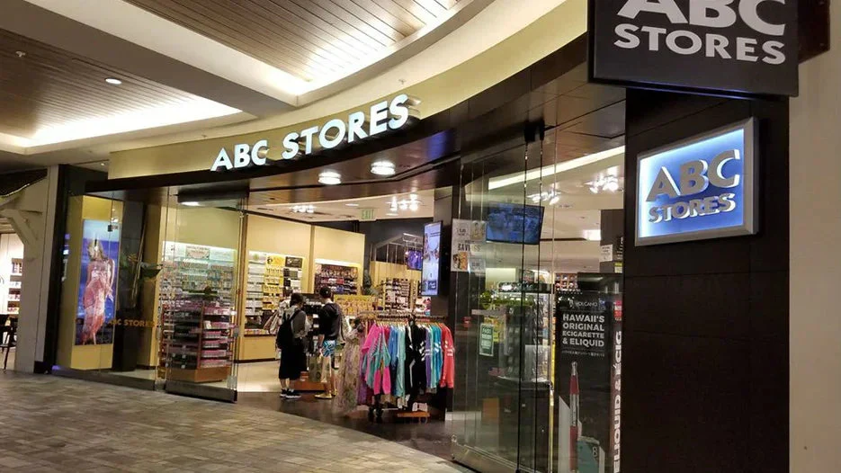 Retail store entrance in a mall with glass doors and clothing displays
