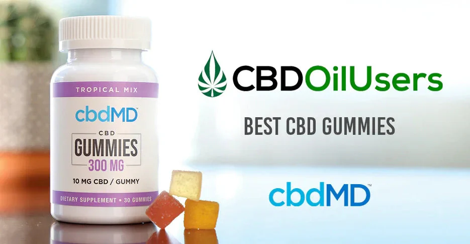 Bottle of tropical mix CBD gummies with assorted gummies on a table, labeled 10mg CBD per gummy.