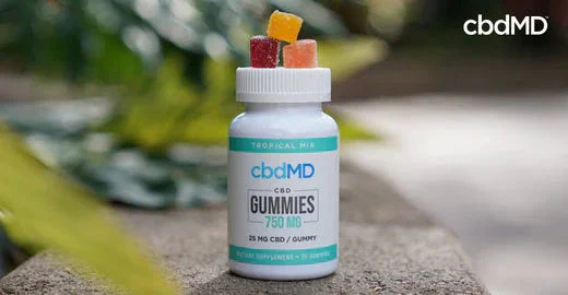 CBD gummies bottle with assorted gummies on lid, outdoor setting, natural health supplement