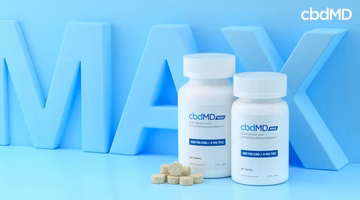 Two white CBD supplement bottles with tablets on a blue background and large MAX letters.