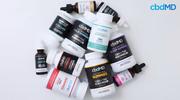 Assorted CBD gummies, softgels, capsules, and oil tinctures arranged on a white background.