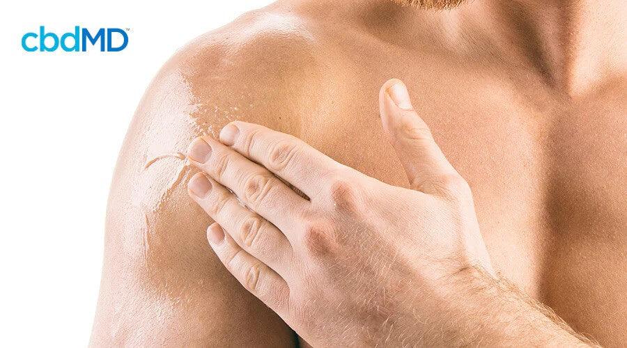 Man applying topical cream to shoulder, skincare and muscle recovery concept