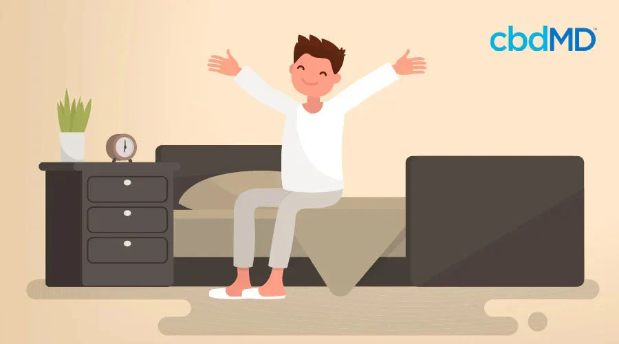 Smiling man stretching on bed in morning, next to nightstand with clock and plant