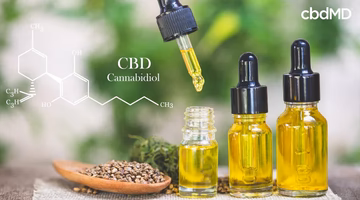 CBD oil dropper bottles with hemp seeds and cannabidiol molecule structure diagram