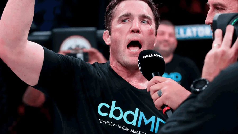MMA fighter in cbdMD shirt speaking into Bellator microphone after match
