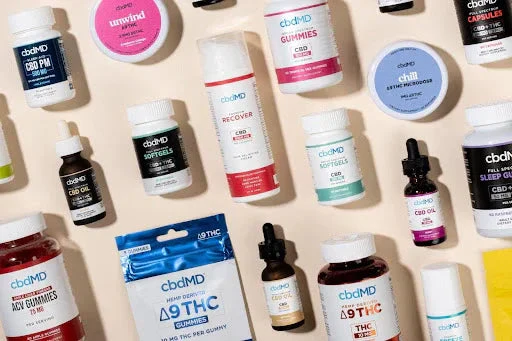 Assorted wellness gummies, oils, and capsules arranged flat lay on a neutral background.