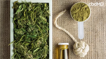 Various hemp products on burlap, including dried hemp, hemp powder, oil, and hemp rope.